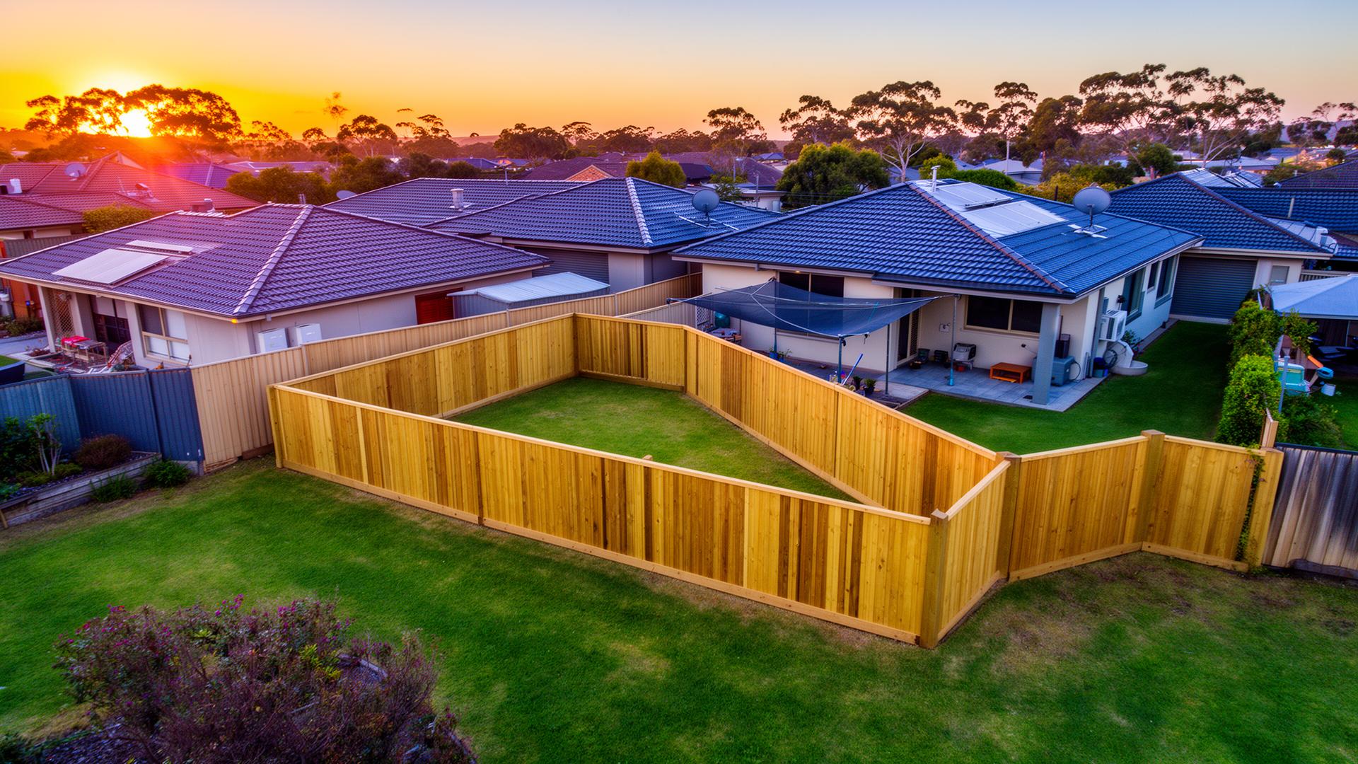 Newly built backyard fence at sunset